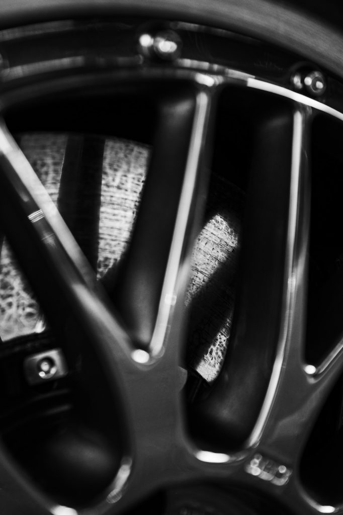 Close-up of a brake disc and calliper behind a wheel