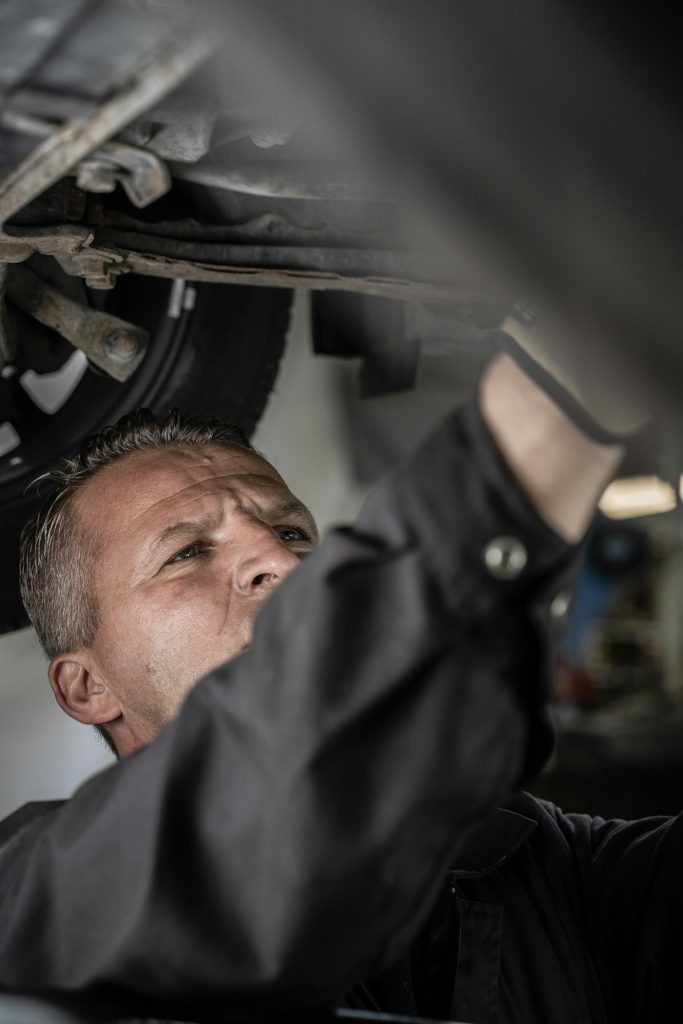 Mechanic working underneath a vehicle