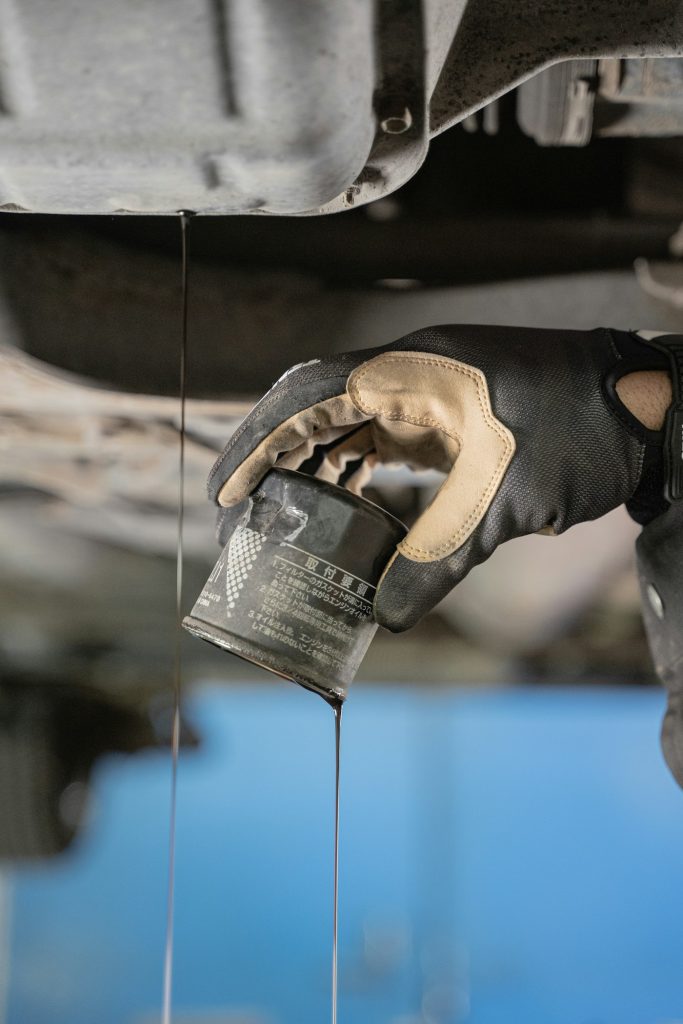 Mechanic pouring fresh oil into an engine