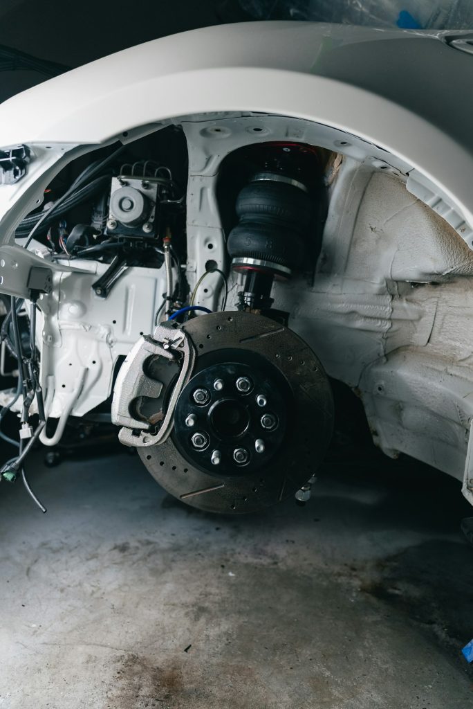 Front suspension and wheel assembly removed for repair